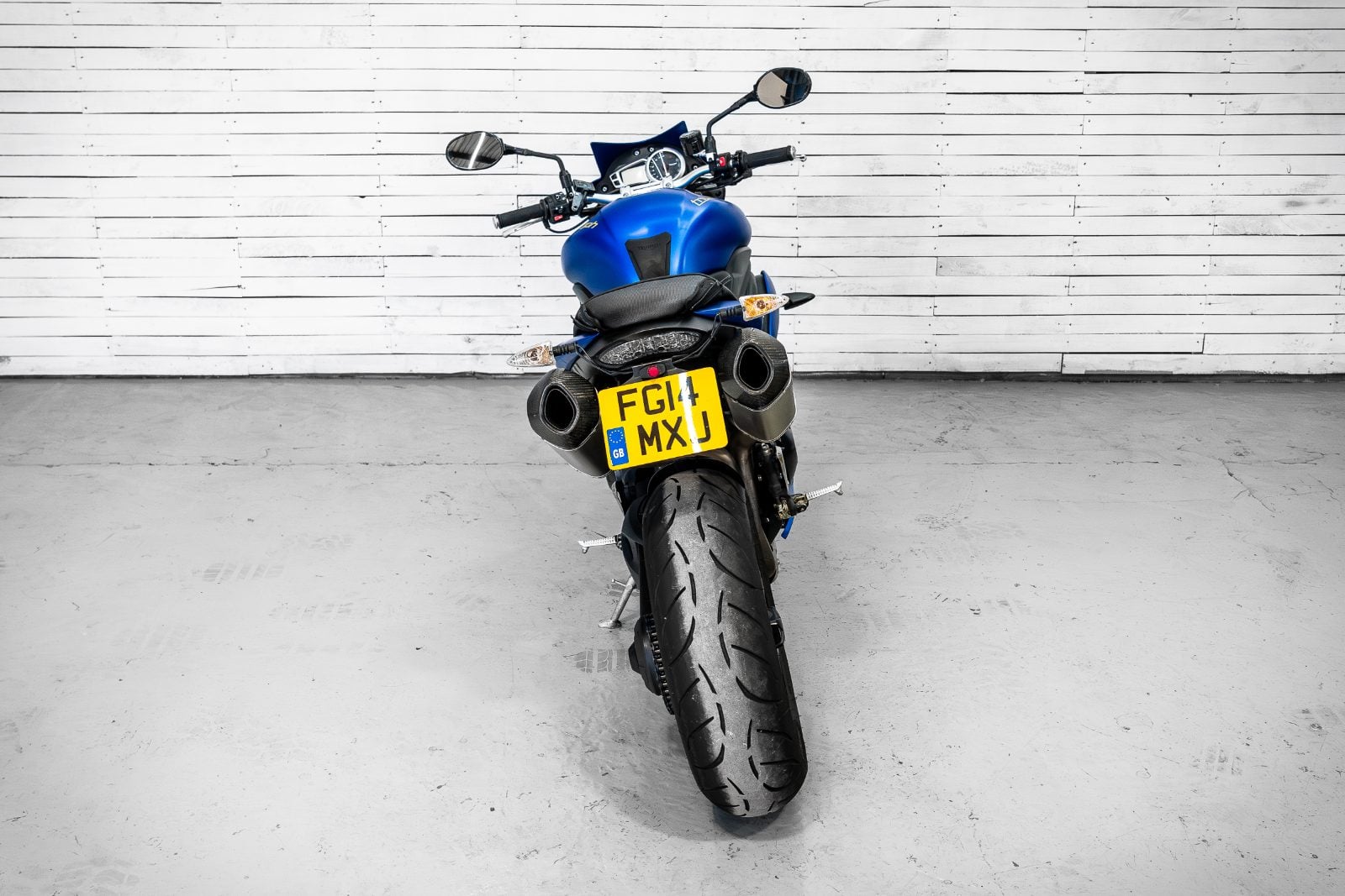 2014 Triumph Speed Triple 1050 ABS in Satin Blue - rear view with twin Arrow exhausts