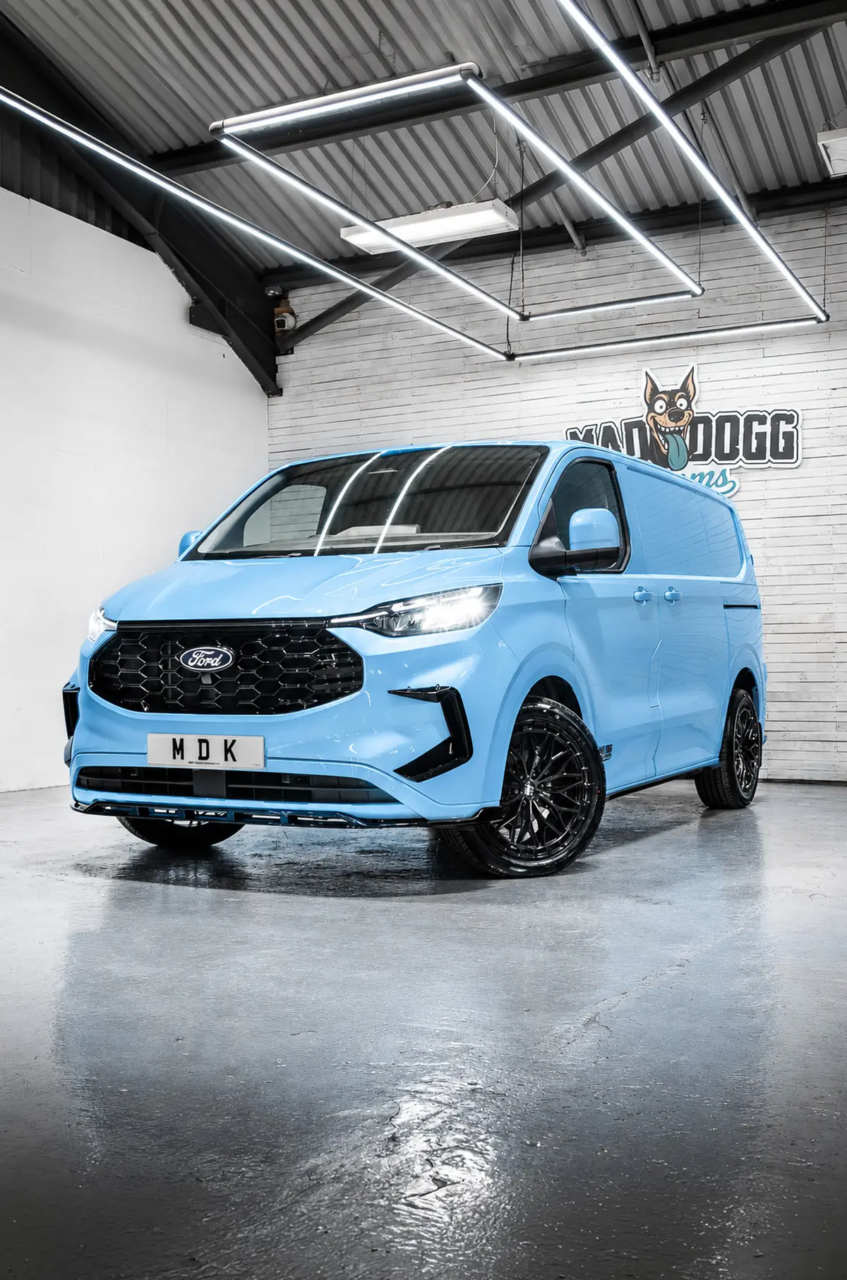 Blue Ford Transit Custom lowered on black alloys
