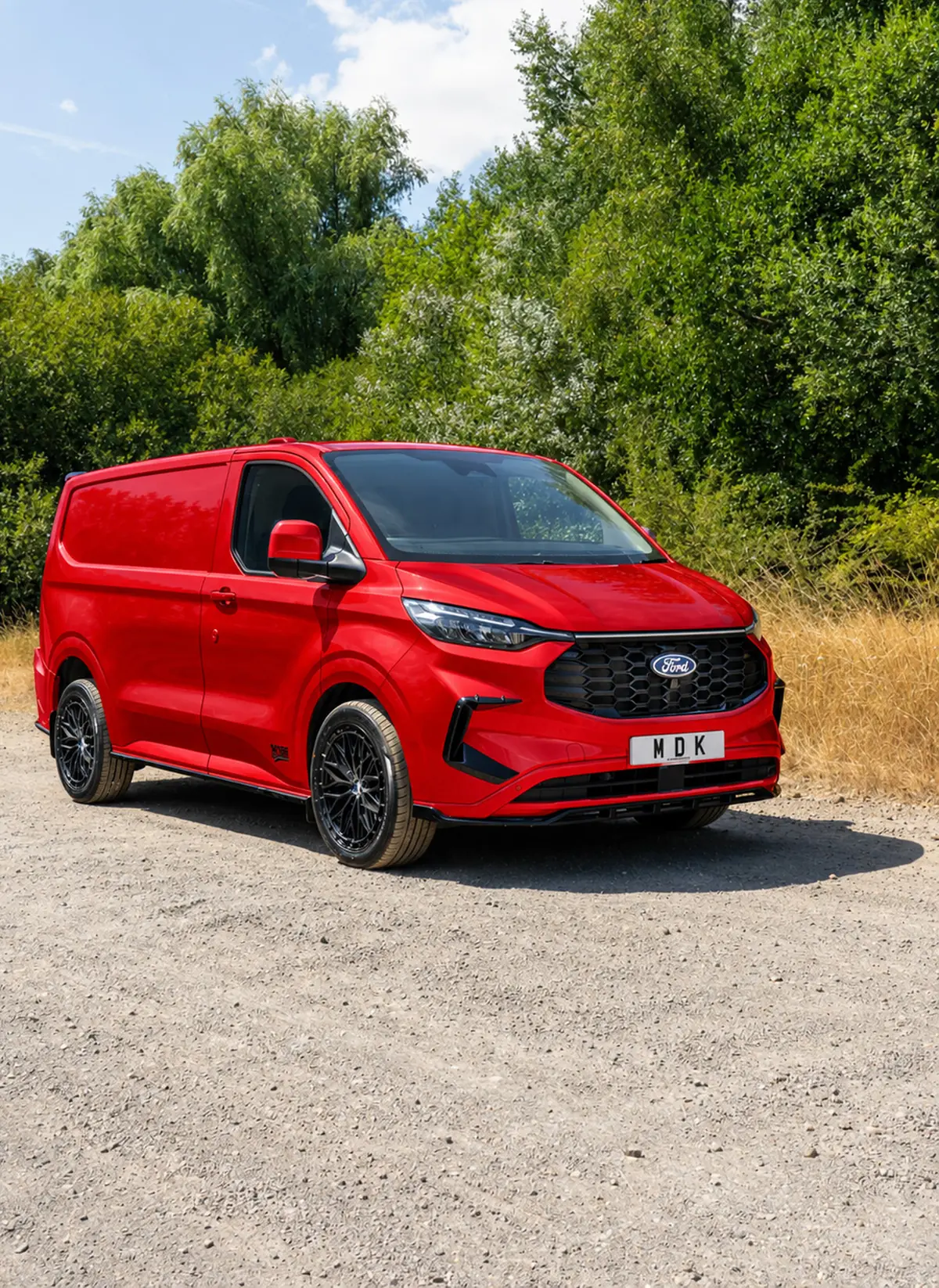 Red Ford Transit Custom with front splitter and black alloys