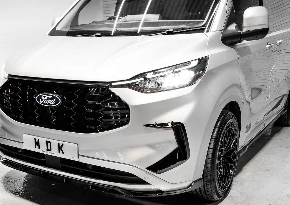 White Ford Transit Custom with gloss honeycomb grille and splitter