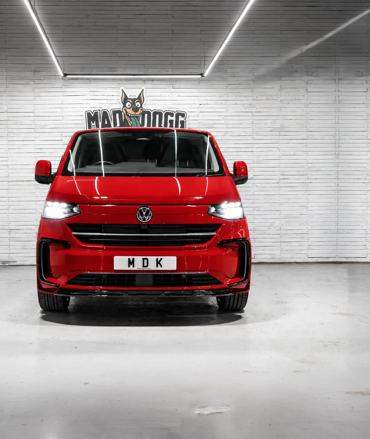 Red VW Transporter T7 with black alloys in the MDK studio